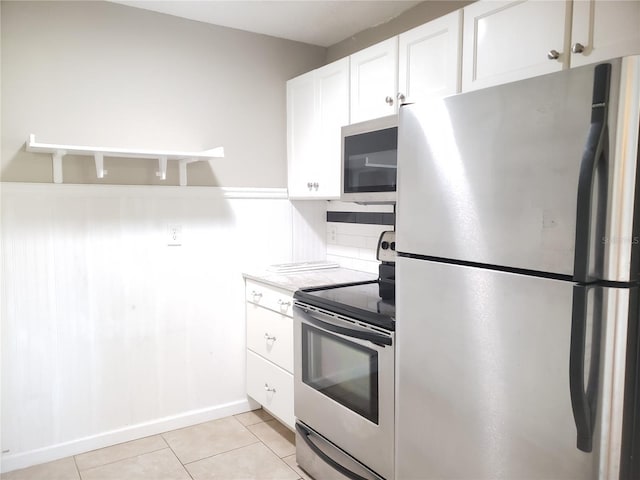 2227 Grenadier Dr Unit 140, Sun City Center, FL 33573 - kitchen with appliances with stainless steel finishes, white cabinetry, light tile patterned floors, and light countertops