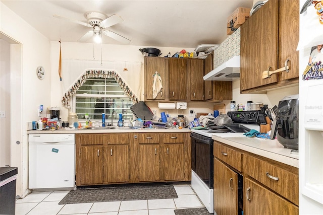 712 Divot Ln, Poinciana, FL 34759 - kitchen with electric stove, dishwasher, ceiling fan, light countertops, and light tile patterned floors