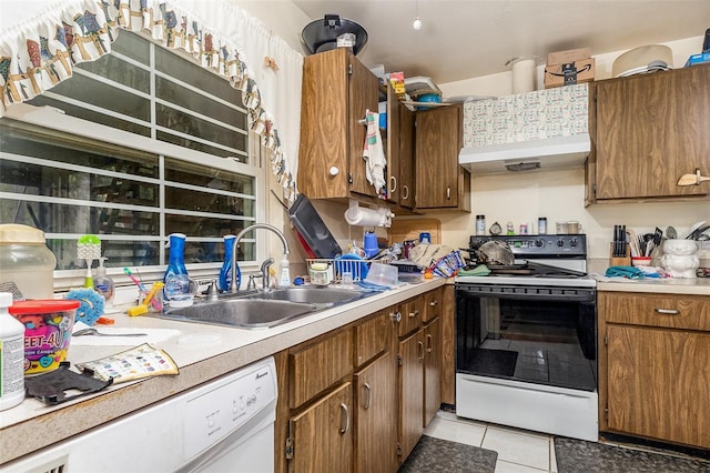 712 Divot Ln, Poinciana, FL 34759 - kitchen featuring white appliances, wall chimney exhaust hood, light tile patterned floors, light countertops, and brown cabinets