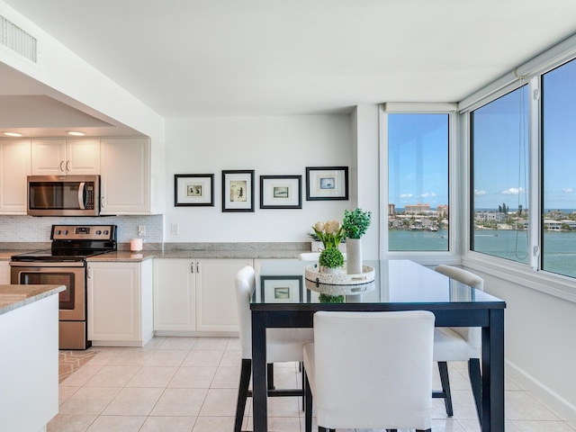 660 Island Way Unit 703, Clearwater Beach, FL 33767 - dining space featuring plenty of natural light and light tile patterned floors