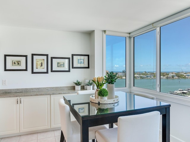 660 Island Way Unit 703, Clearwater Beach, FL 33767 - dining area with plenty of natural light, light tile patterned flooring, and a water view
