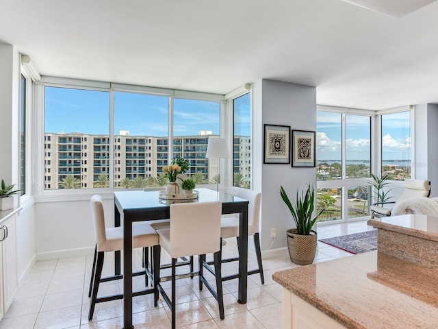 660 Island Way Unit 703, Clearwater Beach, FL 33767 - dining area with light tile patterned floors and floor to ceiling windows