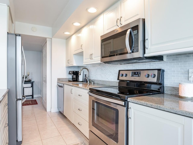 660 Island Way Unit 703, Clearwater Beach, FL 33767 - kitchen featuring stainless steel appliances, light tile patterned flooring, white cabinetry, and recessed lighting