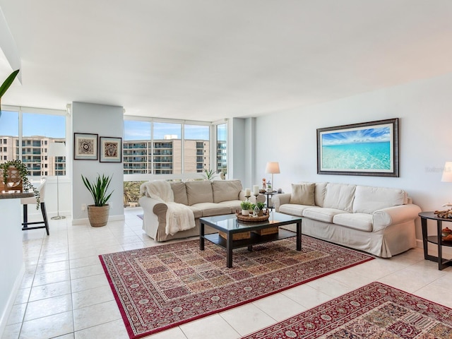 660 Island Way Unit 703, Clearwater Beach, FL 33767 - living room with light tile patterned floors, plenty of natural light, and a wall of windows