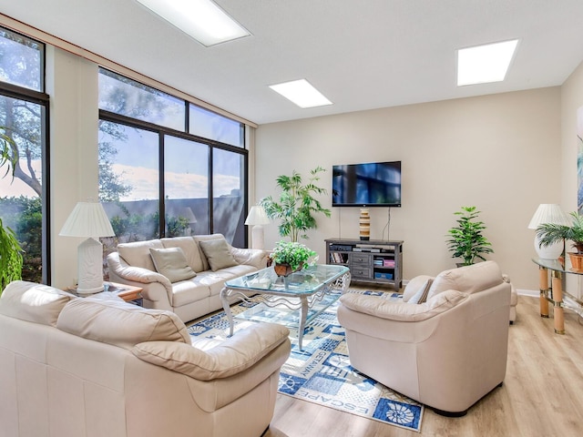 660 Island Way Unit 703, Clearwater Beach, FL 33767 - living area with light wood finished floors, plenty of natural light, and expansive windows