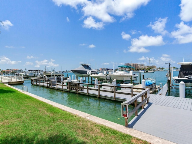 660 Island Way Unit 703, Clearwater Beach, FL 33767 - dock with boat lift, a water view, and a lawn