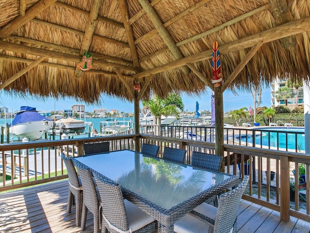 660 Island Way Unit 703, Clearwater Beach, FL 33767 - wooden terrace featuring a gazebo, a community pool, outdoor dining space, a water view, and boat lift