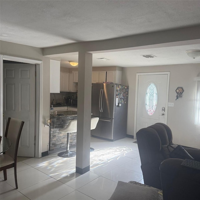 10004 Ethel St, Gibsonton, FL 33534 - entryway featuring a textured ceiling and light tile patterned flooring