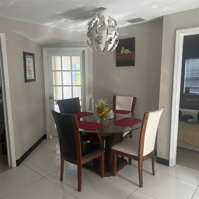 10004 Ethel St, Gibsonton, FL 33534 - dining room featuring a chandelier and light tile patterned flooring