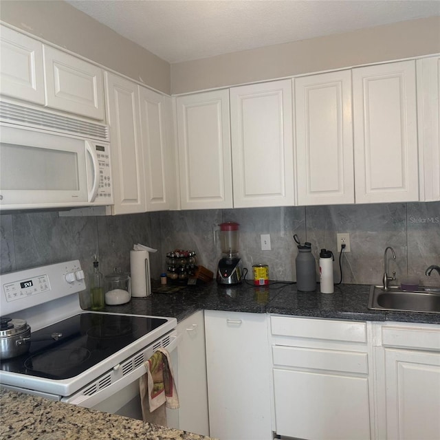 10004 Ethel St, Gibsonton, FL 33534 - kitchen featuring white appliances, white cabinetry, and tasteful backsplash