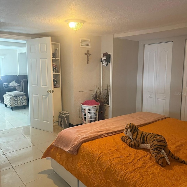 10004 Ethel St, Gibsonton, FL 33534 - bedroom with light tile patterned floors and a textured ceiling
