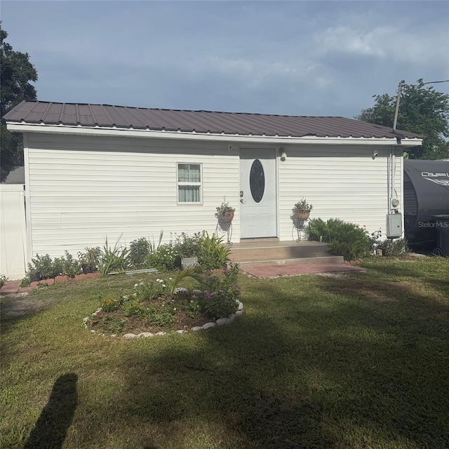 10004 Ethel St, Gibsonton, FL 33534 - view of front of property featuring a front lawn and a metal roof