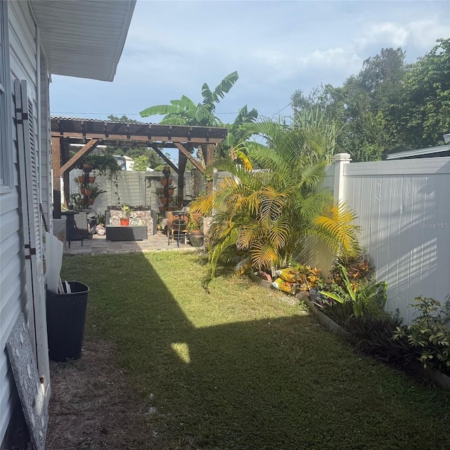 10004 Ethel St, Gibsonton, FL 33534 - fenced backyard with a pergola, a patio, and an outdoor hangout area