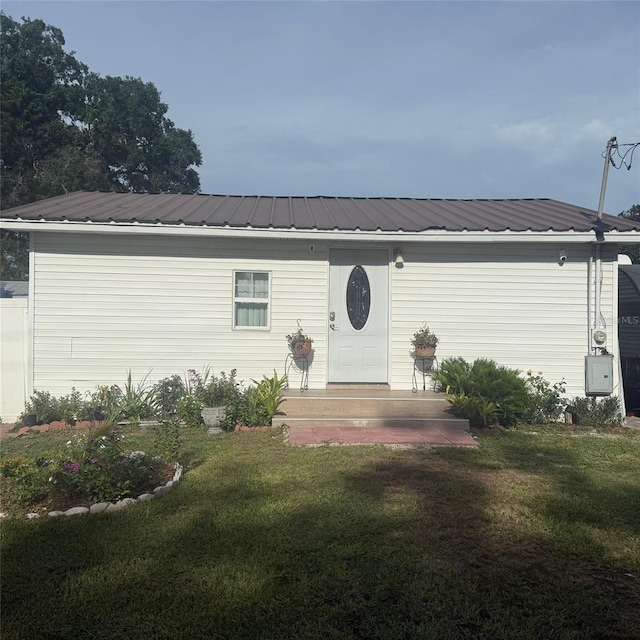 10004 Ethel St, Gibsonton, FL 33534 - view of front of property with a front lawn and a metal roof