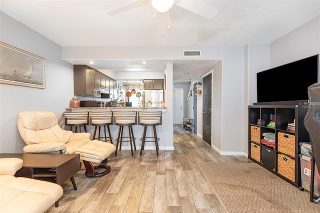 4905 25th St W Unit 101, Bradenton, FL 34207 - living area with light wood-type flooring and a ceiling fan