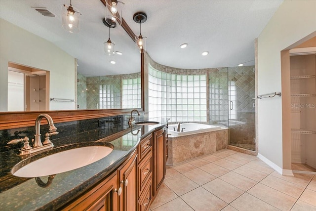 816 Sandringham Ln, Lutz, FL 33549 - bathroom with a garden tub, double vanity, a stall shower, and tile patterned flooring