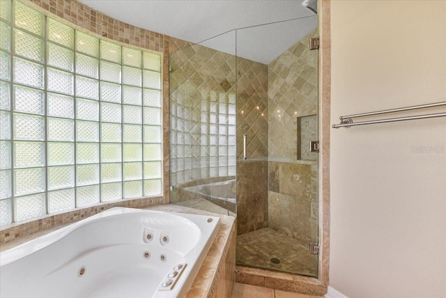 816 Sandringham Ln, Lutz, FL 33549 - full bath featuring healthy amount of natural light, a tub with jets, a stall shower, and tile patterned flooring