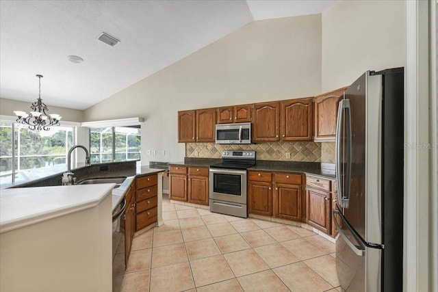 816 Sandringham Ln, Lutz, FL 33549 - kitchen with stainless steel appliances, brown cabinets, tasteful backsplash, pendant lighting, and light tile patterned floors