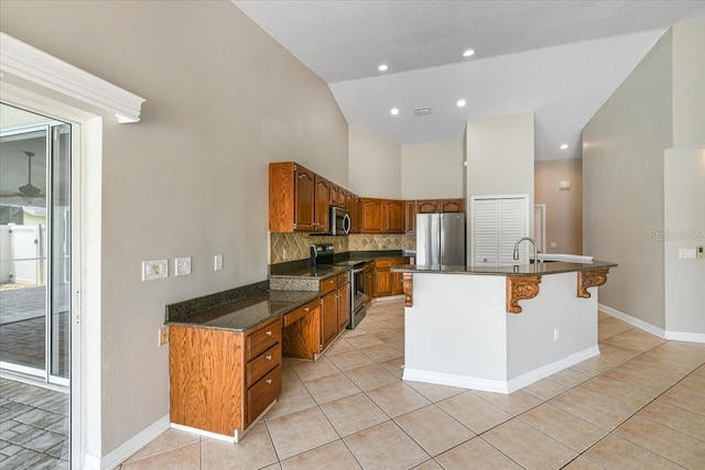 816 Sandringham Ln, Lutz, FL 33549 - kitchen with appliances with stainless steel finishes, light tile patterned floors, high vaulted ceiling, brown cabinetry, and recessed lighting