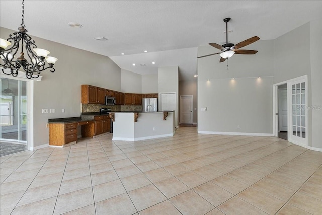 816 Sandringham Ln, Lutz, FL 33549 - kitchen featuring stainless steel appliances, high vaulted ceiling, open floor plan, dark countertops, and light tile patterned flooring