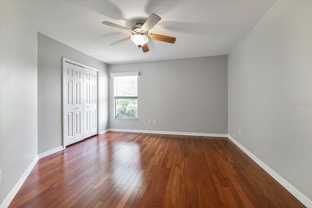 816 Sandringham Ln, Lutz, FL 33549 - unfurnished bedroom featuring dark wood finished floors, a closet, and ceiling fan