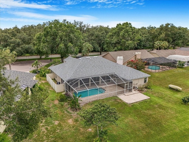 816 Sandringham Ln, Lutz, FL 33549 - outdoor pool with glass enclosure, a patio area, and a lawn