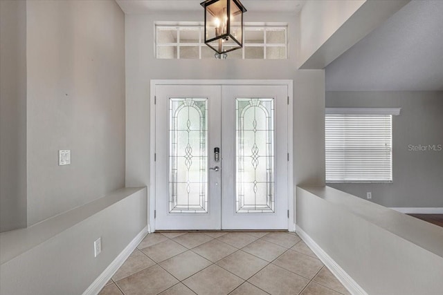 816 Sandringham Ln, Lutz, FL 33549 - entryway featuring french doors, light tile patterned floors, and a chandelier