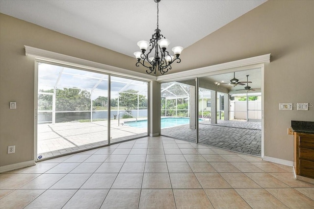 816 Sandringham Ln, Lutz, FL 33549 - unfurnished dining area with light tile patterned floors, plenty of natural light, lofted ceiling, a chandelier, and a ceiling fan