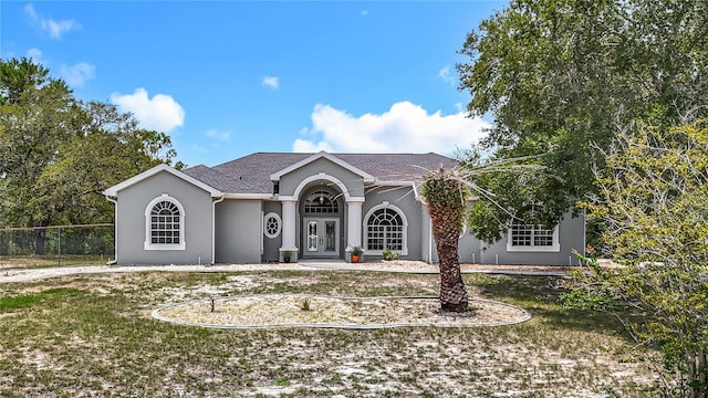 8303 Nightwalker Rd, Weeki Wachee, FL 34613 - ranch-style house with stucco siding and french doors