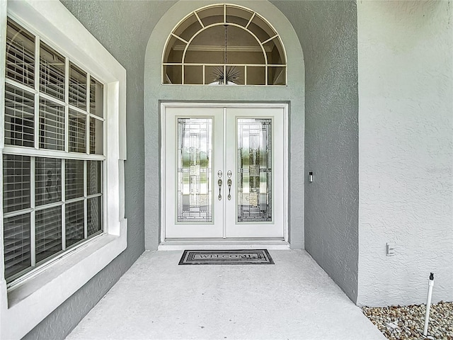 8303 Nightwalker Rd, Weeki Wachee, FL 34613 - doorway to property featuring french doors and stucco siding