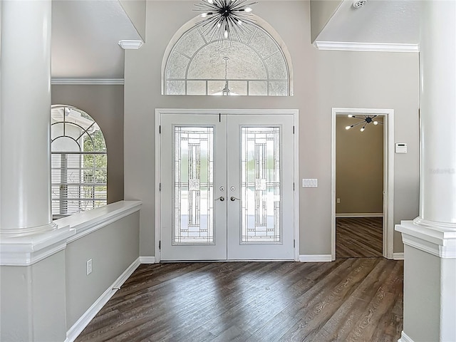 8303 Nightwalker Rd, Weeki Wachee, FL 34613 - entryway with french doors, wood finished floors, crown molding, and a high ceiling