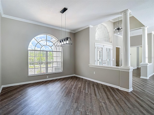 8303 Nightwalker Rd, Weeki Wachee, FL 34613 - unfurnished dining area featuring decorative columns, dark wood-style floors, ornamental molding, and a chandelier