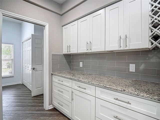 8303 Nightwalker Rd, Weeki Wachee, FL 34613 - kitchen featuring dark wood-style flooring, backsplash, and white cabinetry