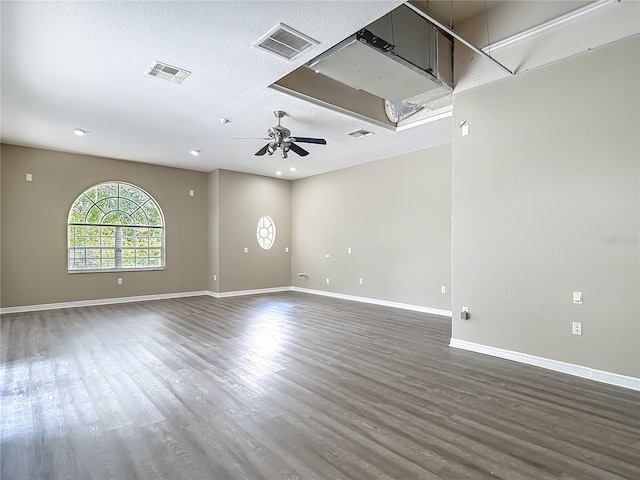 8303 Nightwalker Rd, Weeki Wachee, FL 34613 - empty room with wood finished floors, ceiling fan, recessed lighting, and a textured ceiling
