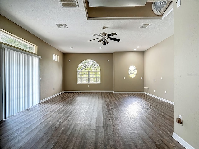 8303 Nightwalker Rd, Weeki Wachee, FL 34613 - unfurnished room featuring wood finished floors, a ceiling fan, a textured ceiling, and attic access