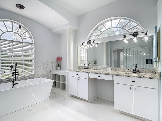 8303 Nightwalker Rd, Weeki Wachee, FL 34613 - full bath with double vanity, decorative columns, a freestanding bath, tile patterned flooring, and walk in shower