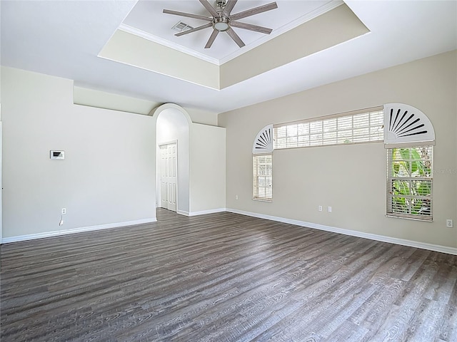 8303 Nightwalker Rd, Weeki Wachee, FL 34613 - unfurnished room with a raised ceiling, ceiling fan, dark wood-style flooring, and crown molding