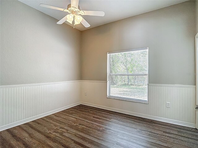 8303 Nightwalker Rd, Weeki Wachee, FL 34613 - spare room with wood finished floors, wainscoting, and ceiling fan