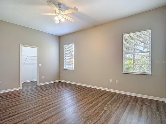 8303 Nightwalker Rd, Weeki Wachee, FL 34613 - empty room featuring healthy amount of natural light, dark wood-type flooring, and a ceiling fan
