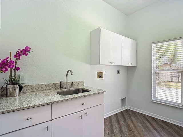 8303 Nightwalker Rd, Weeki Wachee, FL 34613 - laundry room featuring electric dryer hookup, hookup for a washing machine, dark wood-style floors, and cabinet space