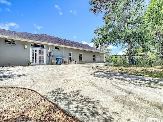 8303 Nightwalker Rd, Weeki Wachee, FL 34613 - rear view of property featuring french doors, a patio, and stucco siding