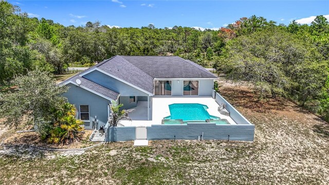 8303 Nightwalker Rd, Weeki Wachee, FL 34613 - swimming pool with a wooded view, a patio area, and a fenced backyard