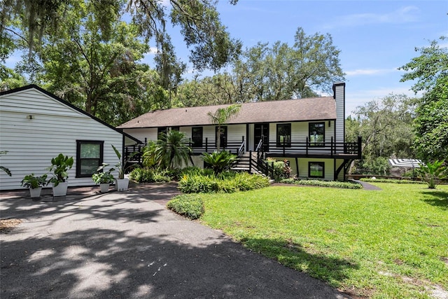 900 Oak Hollow Pl, Brandon, FL 33510 - view of front of property with stairs, a front lawn, and a chimney
