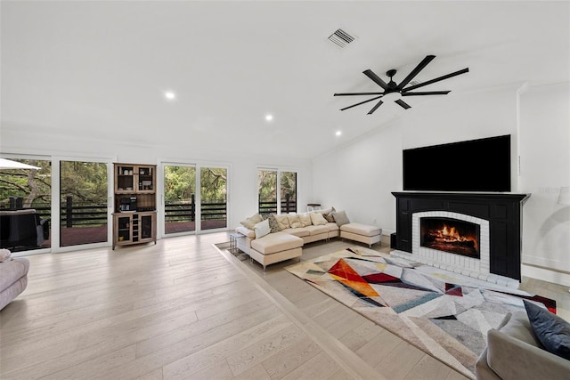 900 Oak Hollow Pl, Brandon, FL 33510 - living room featuring a fireplace, healthy amount of natural light, crown molding, light wood-type flooring, and vaulted ceiling