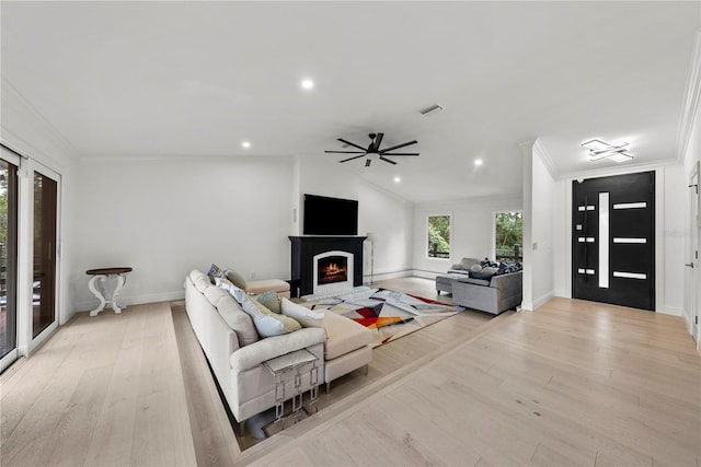 900 Oak Hollow Pl, Brandon, FL 33510 - living area with light wood finished floors, a brick fireplace, crown molding, ceiling fan, and recessed lighting