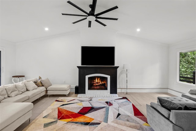 900 Oak Hollow Pl, Brandon, FL 33510 - living room with wood finished floors, a ceiling fan, a brick fireplace, lofted ceiling, and crown molding