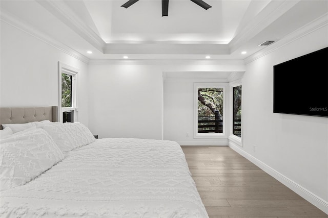 900 Oak Hollow Pl, Brandon, FL 33510 - bedroom with multiple windows, wood finished floors, recessed lighting, a tray ceiling, and a ceiling fan