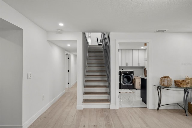 900 Oak Hollow Pl, Brandon, FL 33510 - stairs featuring washer / dryer, wood finished floors, and recessed lighting
