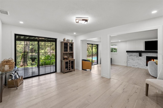 900 Oak Hollow Pl, Brandon, FL 33510 - living room featuring wood finished floors, a stone fireplace, and recessed lighting