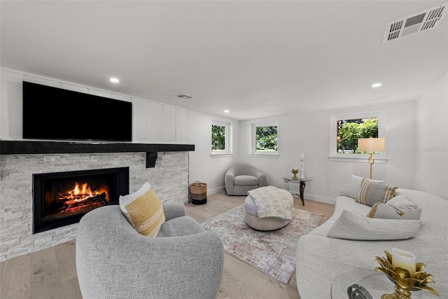 900 Oak Hollow Pl, Brandon, FL 33510 - living room with a fireplace, light wood-type flooring, and recessed lighting